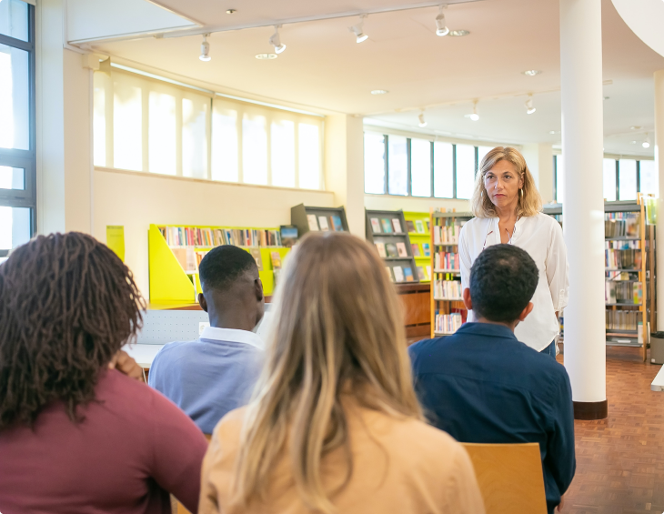 female-african-american-speaker-giving-presentation-hall-university-workshop_155003-3579 (1) 1